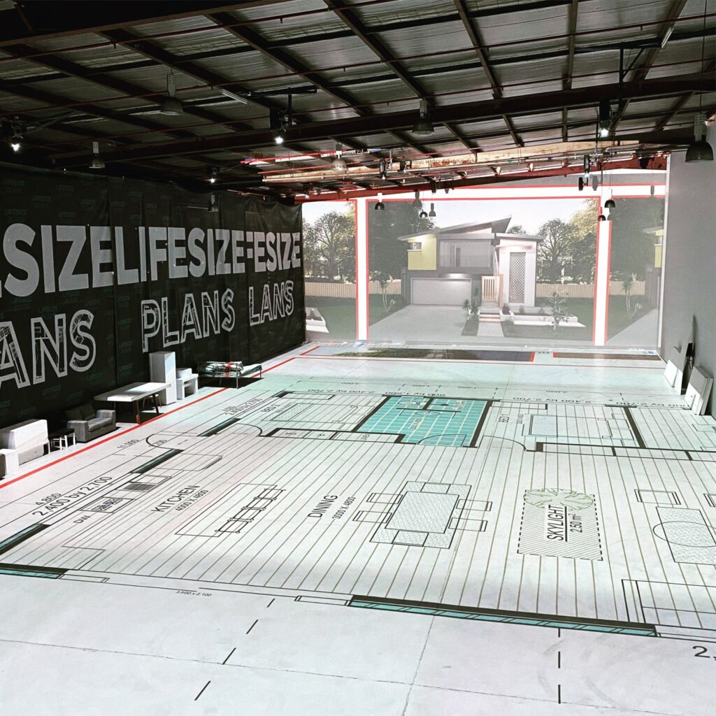 A spacious room with a floor plan displayed on the wall.